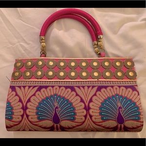 Peacock snap woven clutch